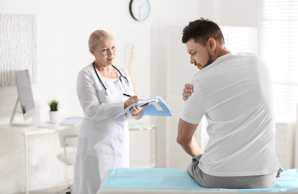 Patient discussing shoulder pain with doctor
