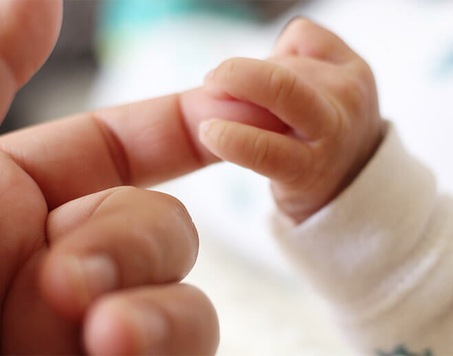 newborn grabbing finger
