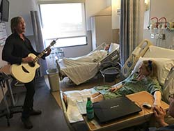David Victor performing for patients